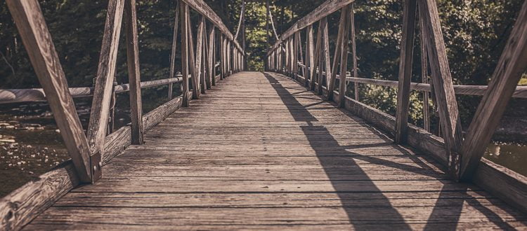a wooden bridge with railings