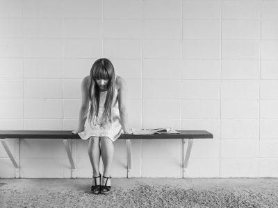 a woman sitting on a bench
