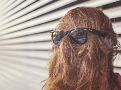 a person wearing sunglasses and a wig