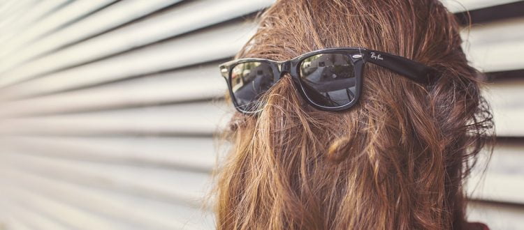 a person wearing sunglasses and a wig