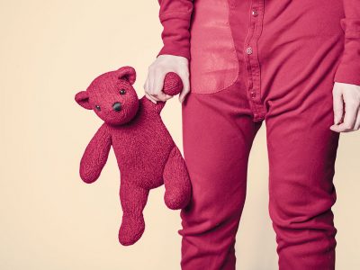 a person holding a stuffed bear