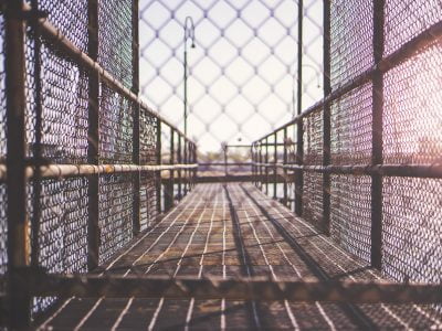 a chain link fence with a walkway