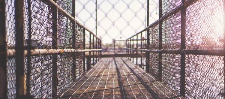 a chain link fence with a walkway