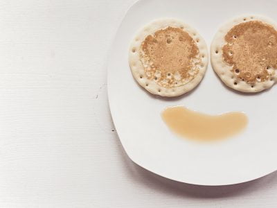 pancakes on a plate with syrup on it