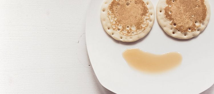 pancakes on a plate with syrup on it