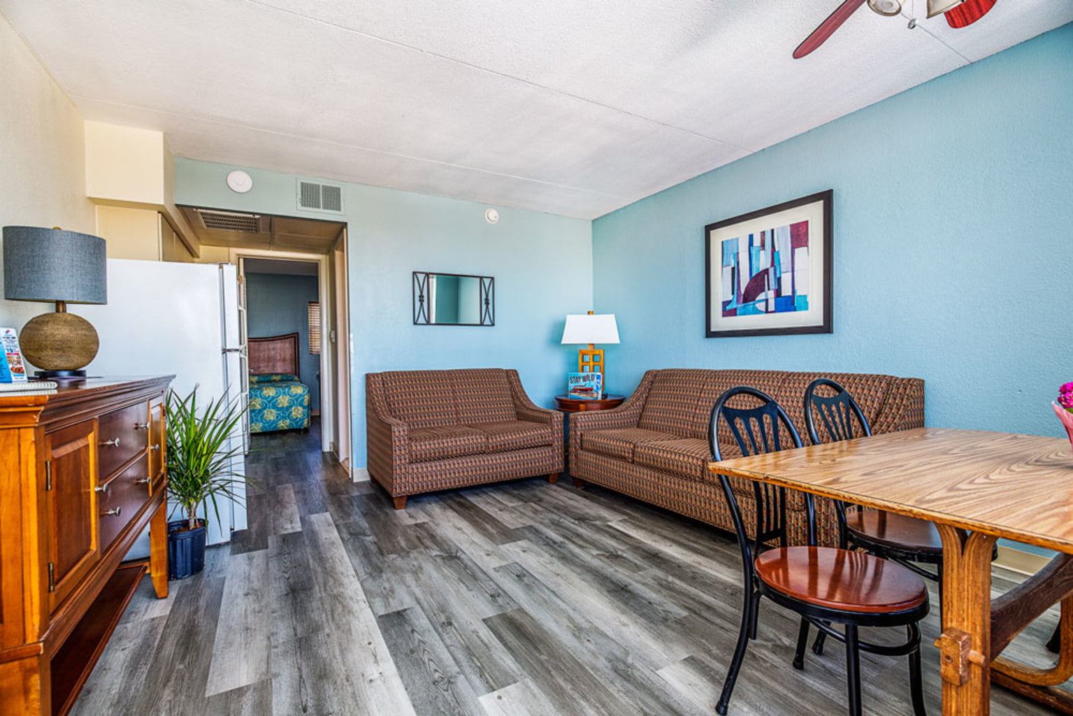 a living room with a table and chairs at The Crusader