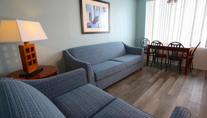 a living room with couches and a table at The Crusader