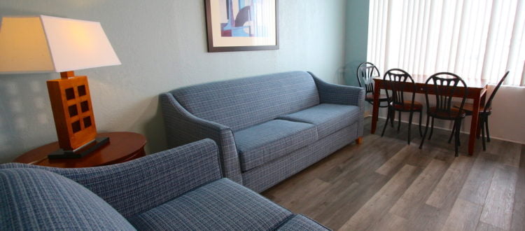 a living room with couches and a table at The Crusader