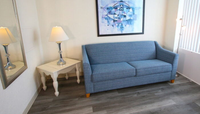 a couch and a lamp in a room at The Crusader resort