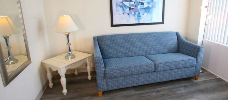 a couch and a lamp in a room at The Crusader resort