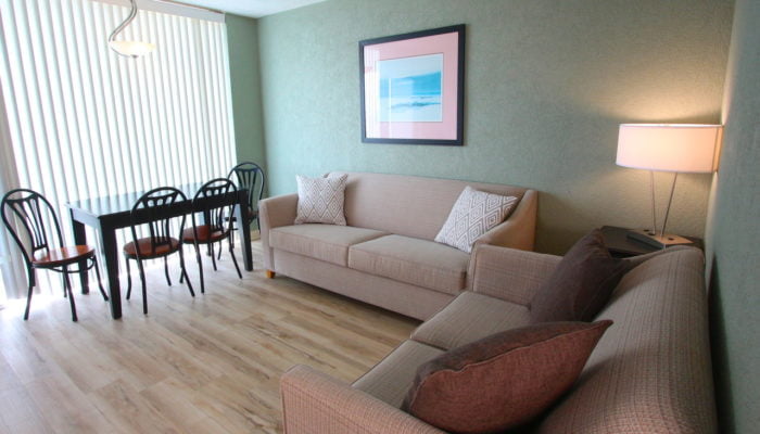 a living room with a couch and table at the Crusader