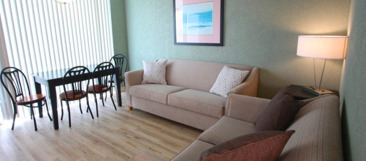 a living room with a couch and table at the Crusader