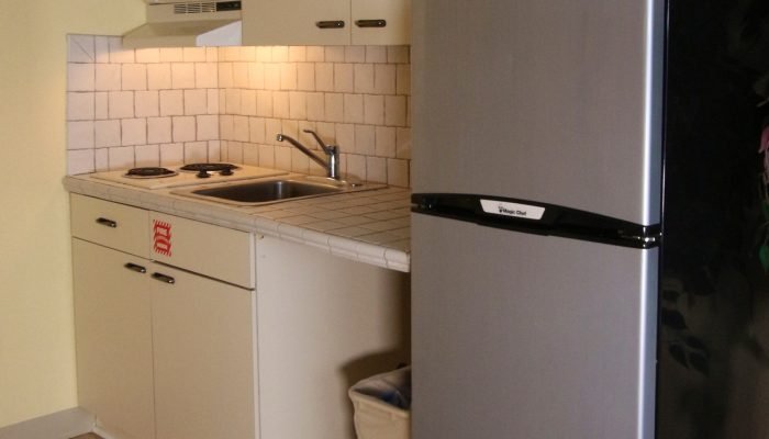 a kitchen with a refrigerator and sink