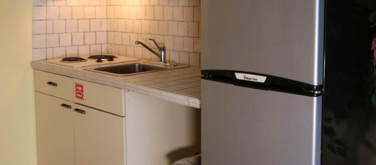 a kitchen with a refrigerator and sink